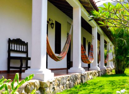 Several Orange Hammocks Hanged On White Concrete Posts photo