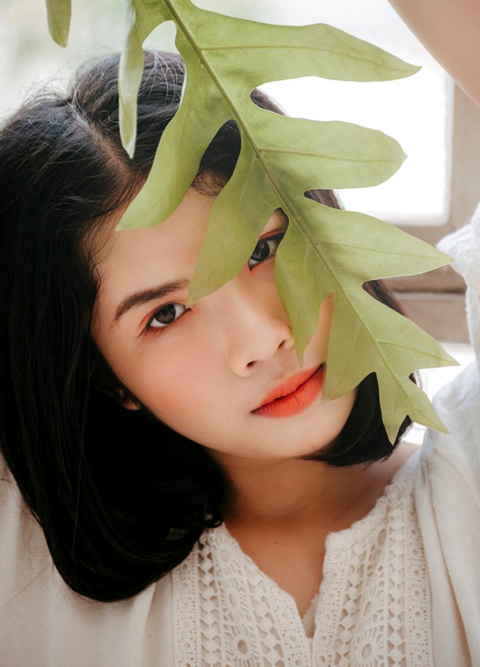 Close-Up Photography Of A Woman Near Leaves