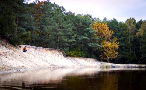 Person Seated Facing Body Of Water