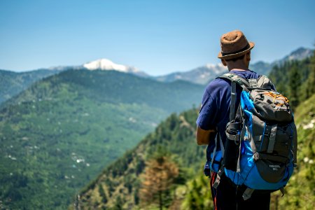 Selective Focus Photography Of Man Carrying Hiking Pack photo