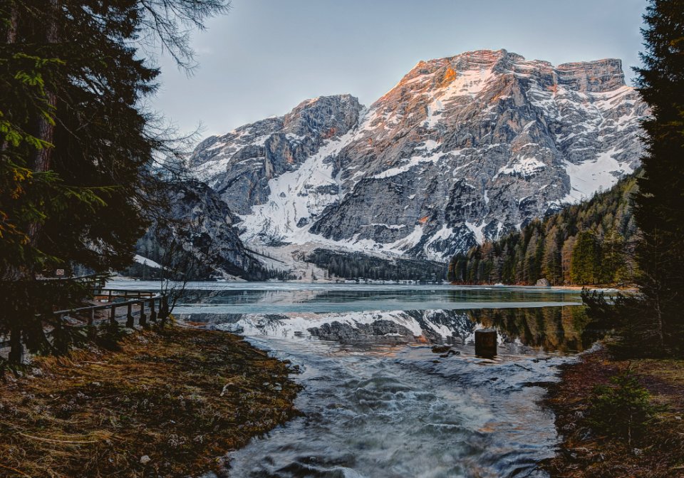 Landscape Photography Of Body Water Across Mountain