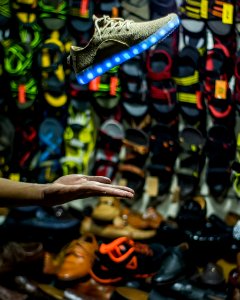 Person Hand Near Assorted Footwear