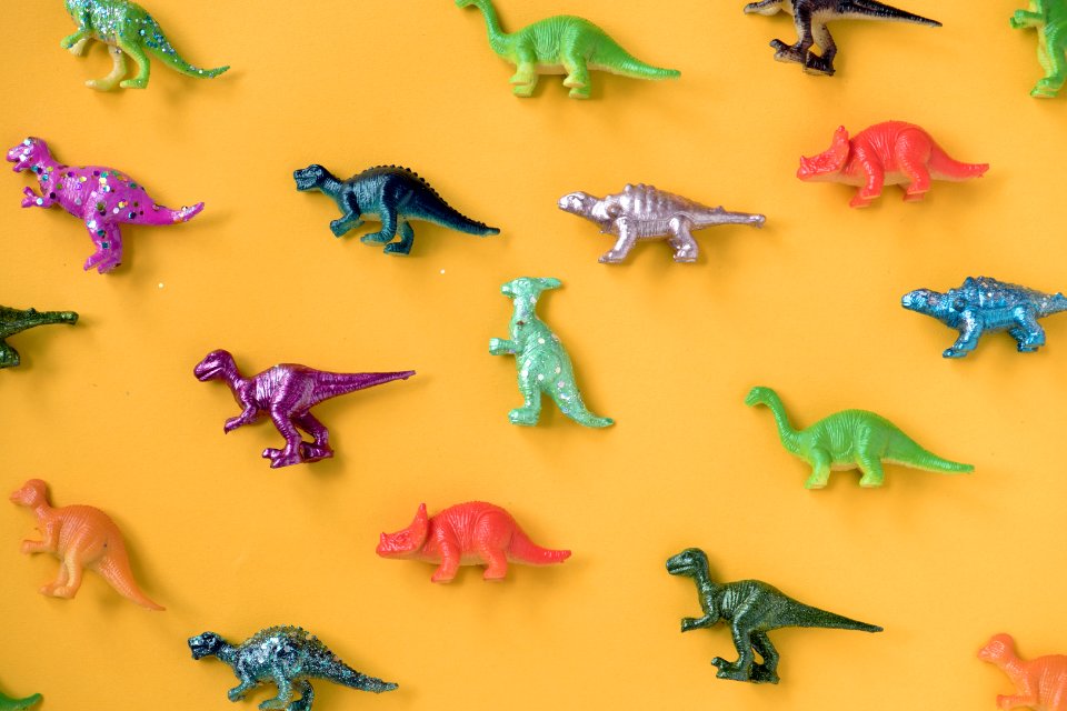 Various Animal Toy Figures In A Colorful Background