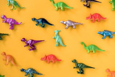 Various Animal Toy Figures In A Colorful Background