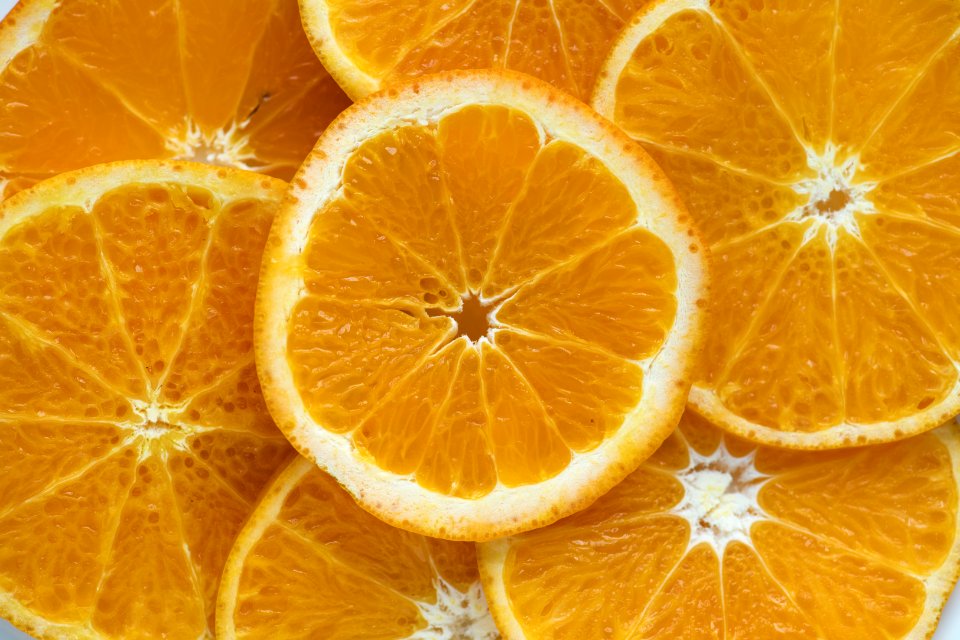 Closeup Of Sliced Juicy Oranges Textured Background