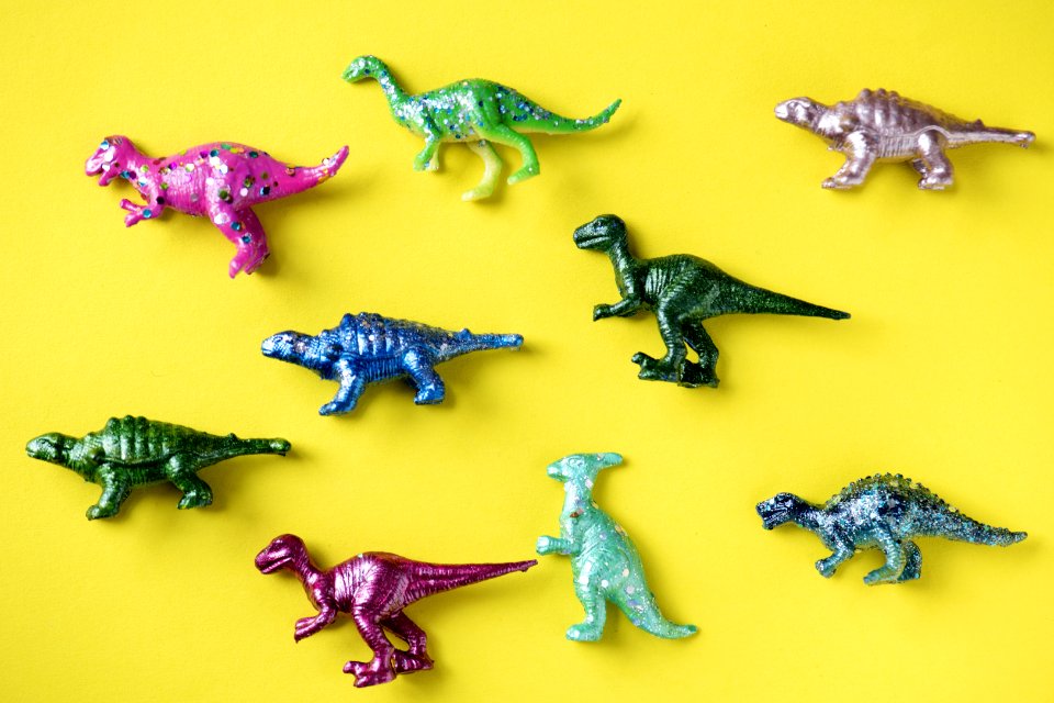 Various Animal Toy Figures In A Colorful Background
