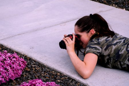 Woman Lying On Pavement While Taking Photo photo