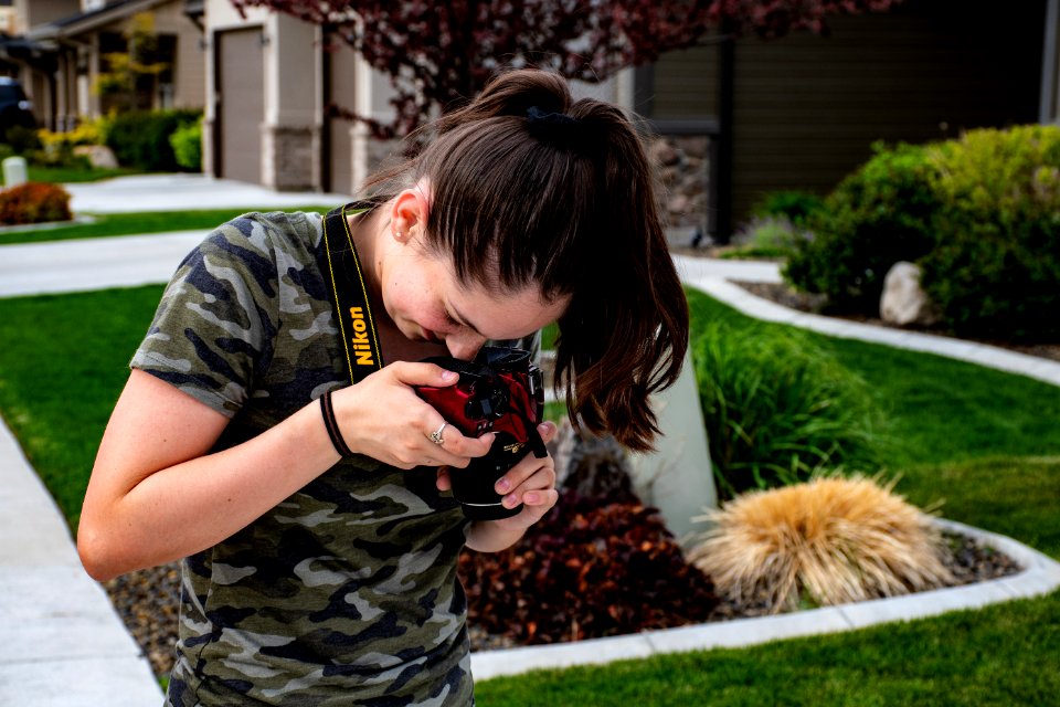 Woman Taking A Picture Of Floor Using Nikon Camera