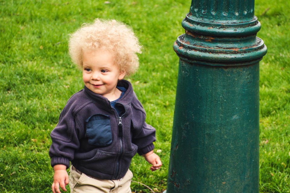 Toddler Wearing Jacket Beside The Light Post