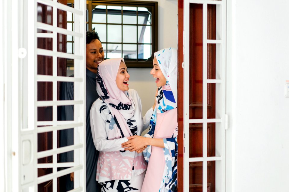 Two Women Standing By The Door