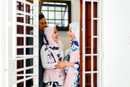 Two Women Standing By The Door