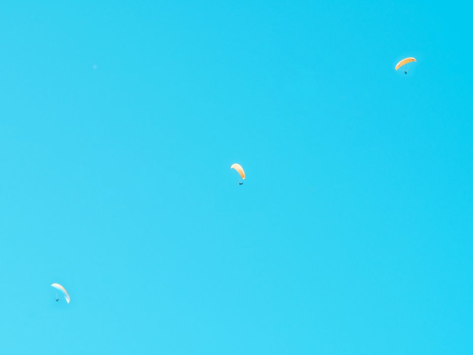 Photo Of Three Person In Parachutes