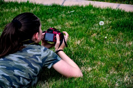 Woman In Camouflage T-shirt Holding Dslr Camera
