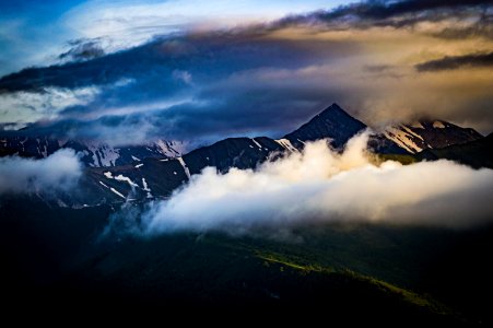 Cumulus Clouds Over Mountain Peak