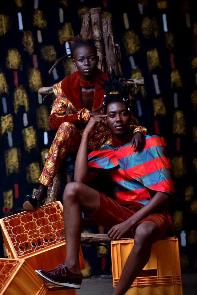 Couple Sitting And Standing On Crates For Photo