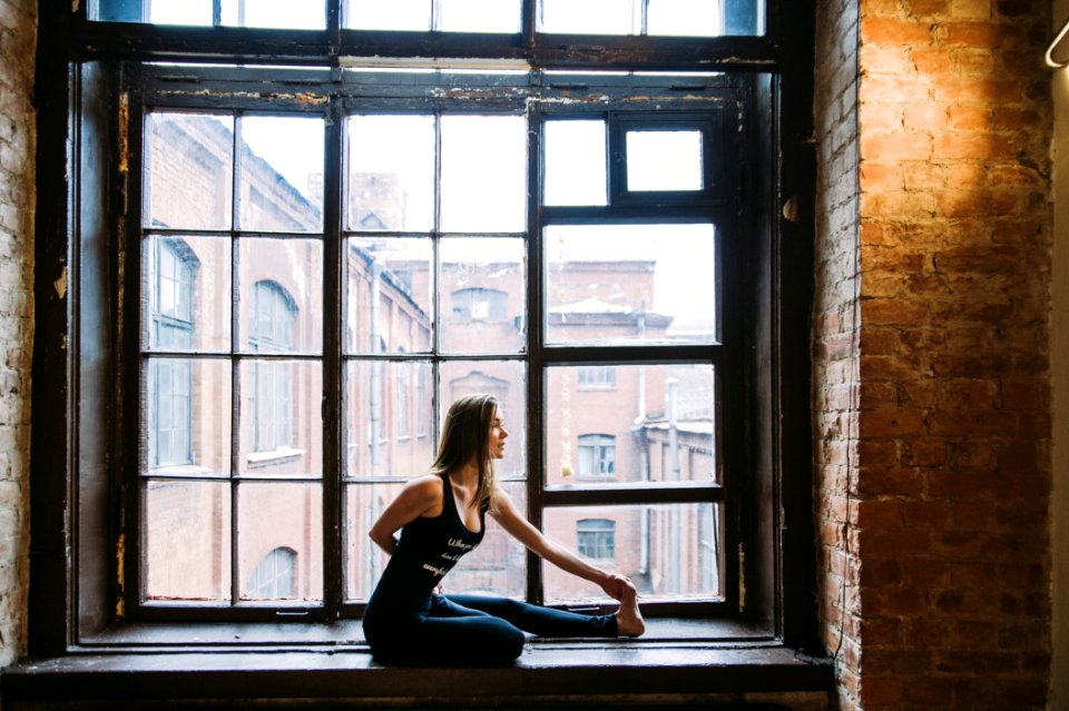 Woman Stretching Beside Window