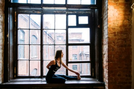 Woman Stretching Beside Window photo
