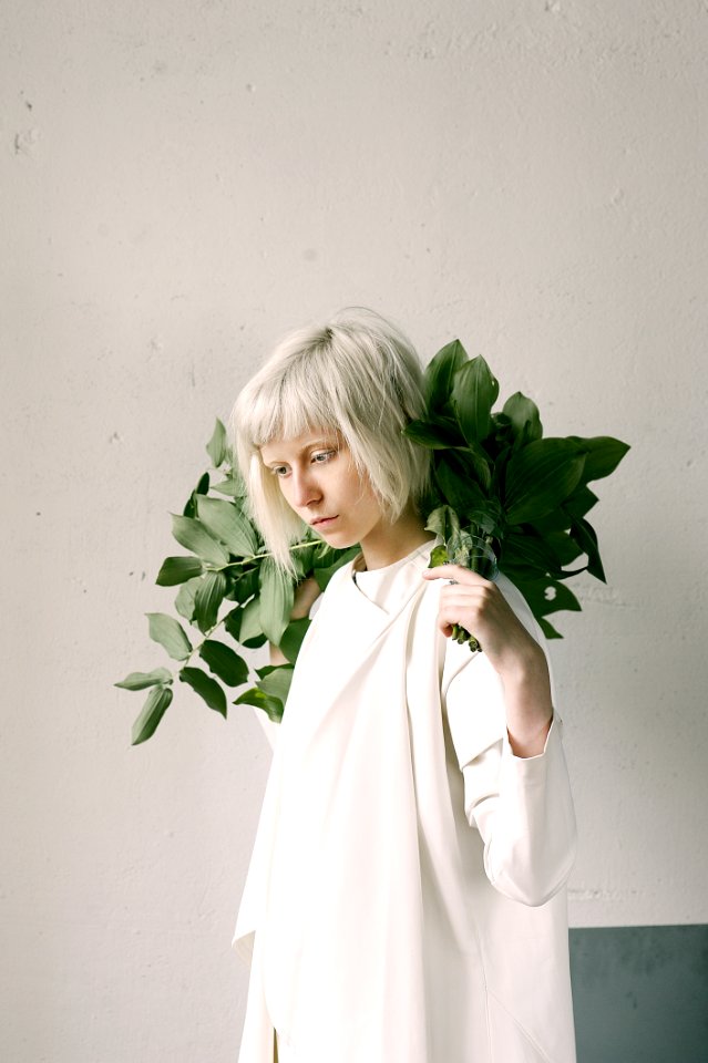 Photography Of A Woman Holding Green Leaves
