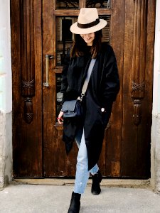 Photo Of Woman Wearing Black Coat And Faded Blue Jeans photo