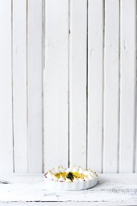 Round White Bowl Of Foods On White Wooden Panel