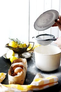 White Plastic Container Beside Basket Of Brown Eggs photo