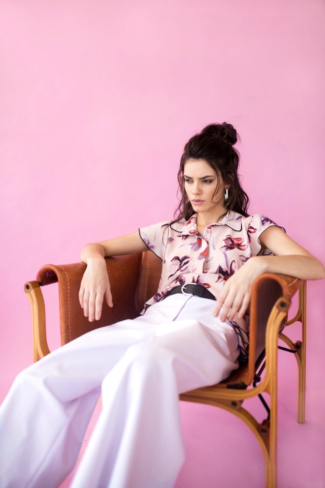 Photography Of A Woman Sitting On Chair