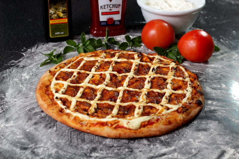 Baked Pizza Beside Two Red Tomatoes