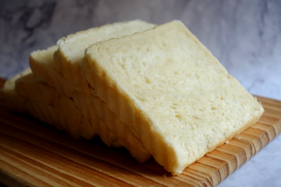 Photo Of Sliced Bread On Brown Wooden Chopping Board
