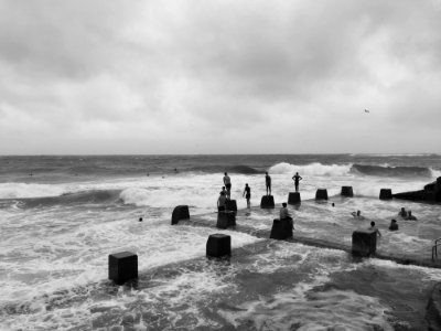 Grayscale Photo Of People In Beach photo