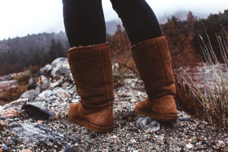 Close-Up Photography Of A Person Wearing Brown Winter Boots photo