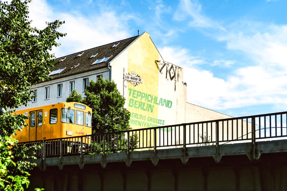 Yellow Train Beside Teppichland Berun Building