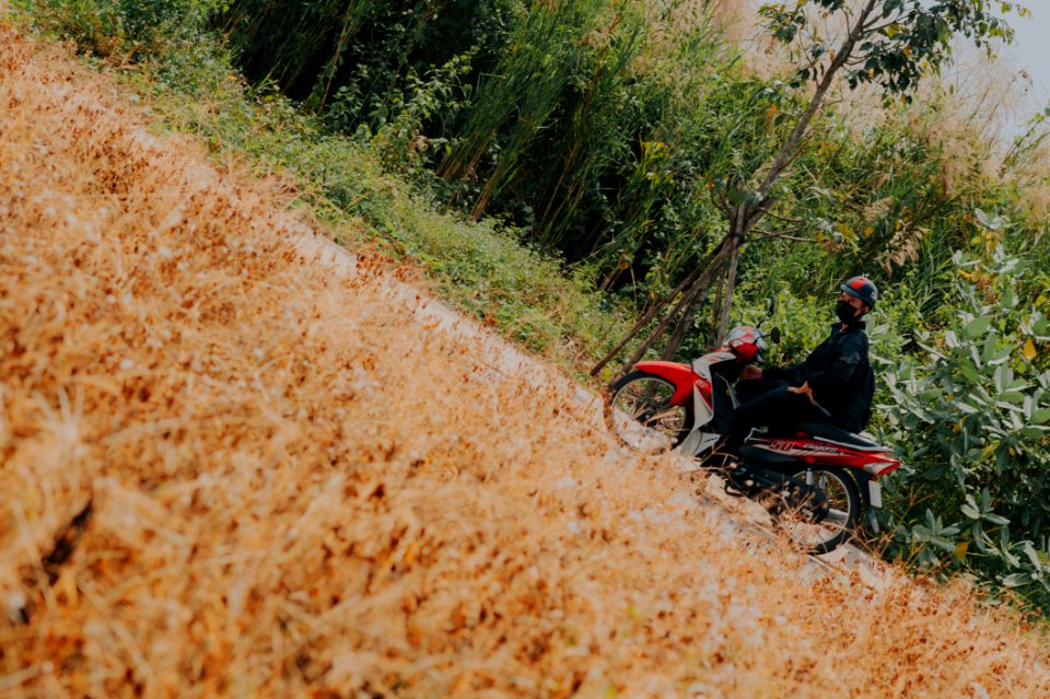 Man On White And Red Underbone Motorcycle
