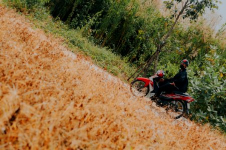 Man On White And Red Underbone Motorcycle photo