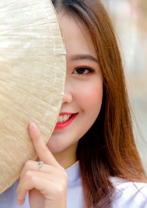 Photo Woman Hiding On Asian Conical Hat photo