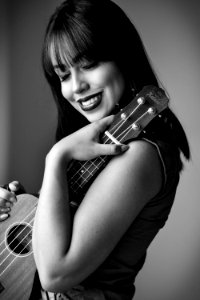 Greyscale Photo Of Woman Holding Ukulele photo