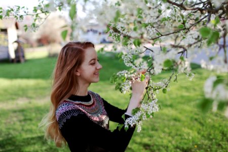 Woman In Black Sweater Holding Flowers photo