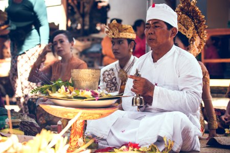 Man Sitting In Front Of Woman Near Table Performing Ritual Ceremony photo