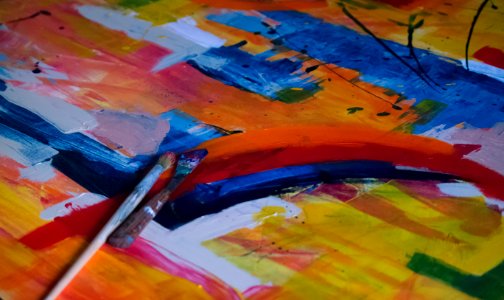 Two Paintbrushes On Multicolored Abstract Painting