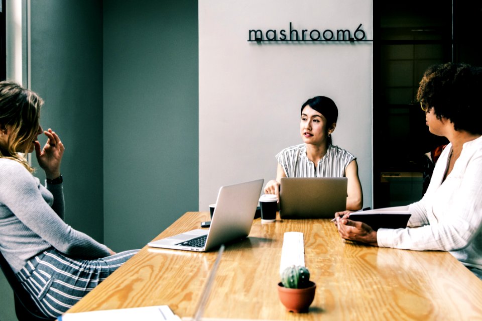 Three People Discussing Inside The Conference Room