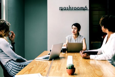 Three People Discussing Inside The Conference Room