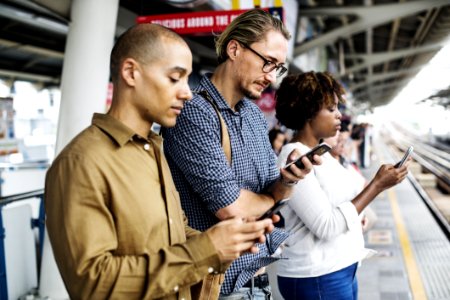 Three Person Holding Smartphones photo