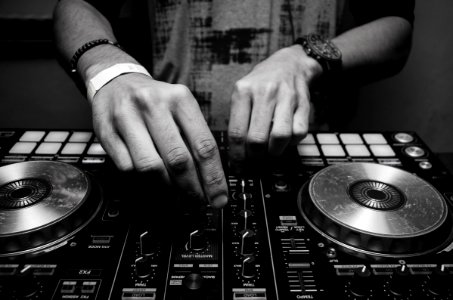 Grayscale Photography Of Person Using Dj Controller
