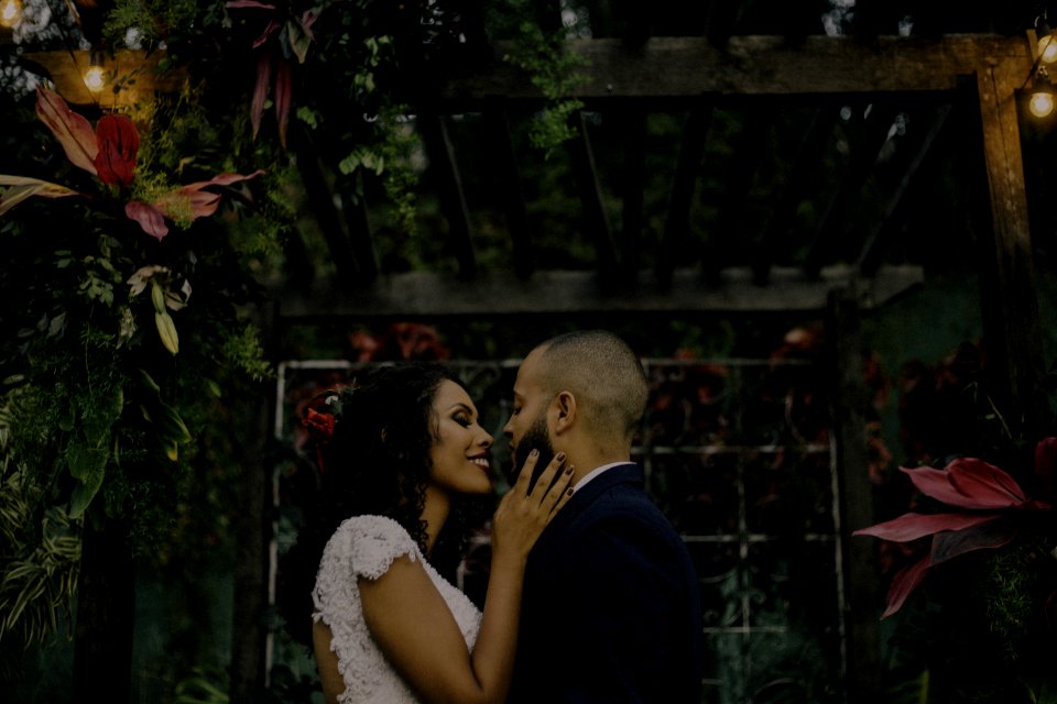 Couple Under Garden Arch Surrounded With Flowers