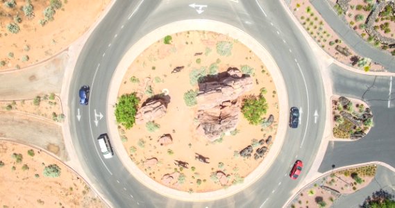 Aerial Photo Of Four Cars On Round About At Daytime