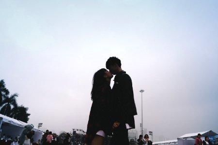 Couple Kissing Together Standing Near People photo