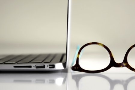 Black Framed Eyeglasses Beside Laptop Computer photo