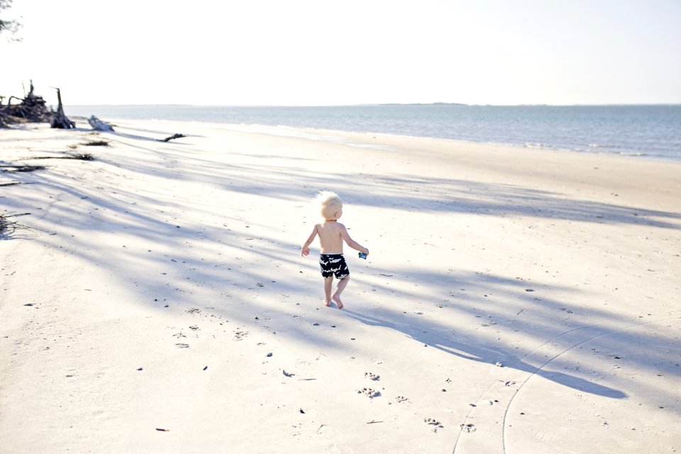 Boy Walking On Beach