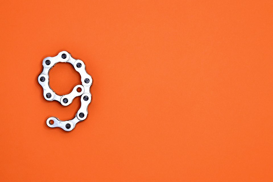 Gray Bicycle Chain On Orange Surface