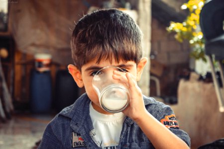 Boy Holding Clear Drinking Glass