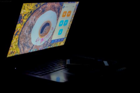 White Android Smartphone On Top Of Turned On Black Laptop Computer